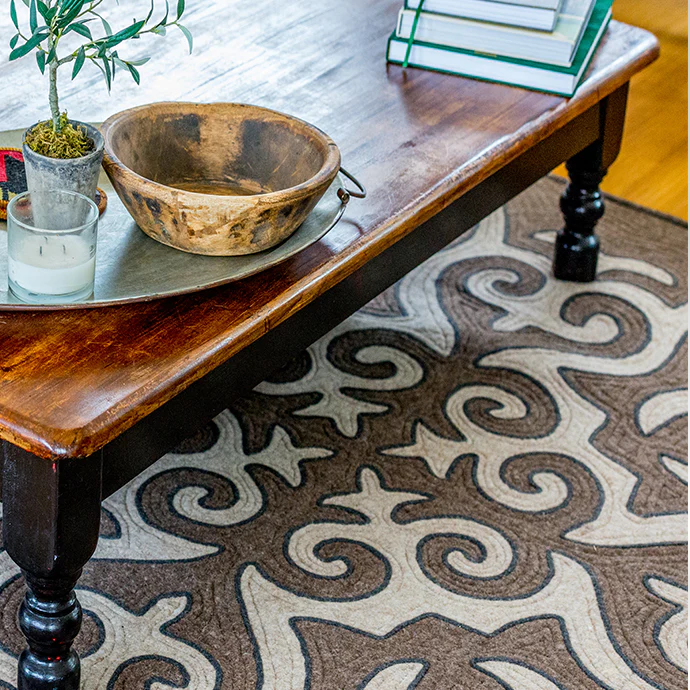 Shrydak rugs image alongside a wooden table and dishes